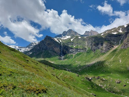 Green and Brown Mountains Under Blue Sky and White Clouds