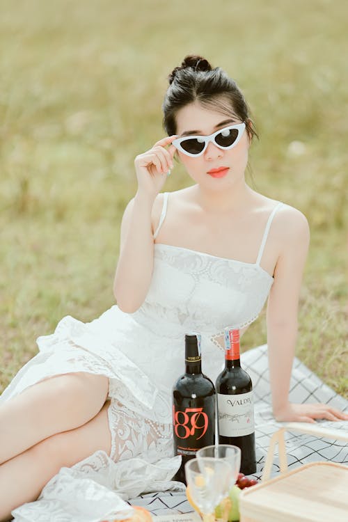 Woman on Blanket with Bottles of Wine