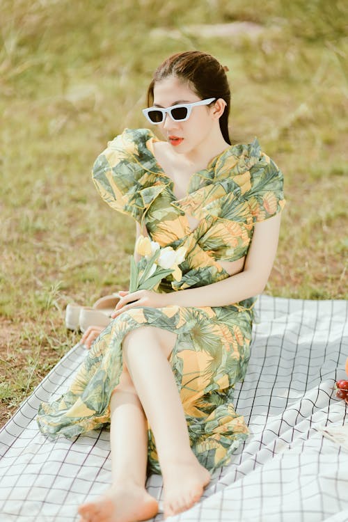 A Woman in Green Floral Dress Wearing Sunglasses