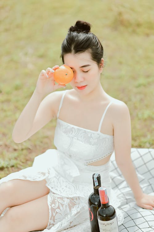 A Woman Holding an Orange Fruit