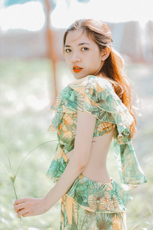 A Woman Green Dress Looking at the Camera