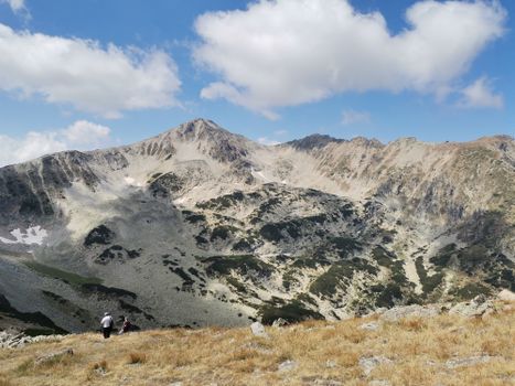 Explore the serene landscape of Mount Vihren in the Pirin Mountains, Bulgaria, under a clear blue sky.