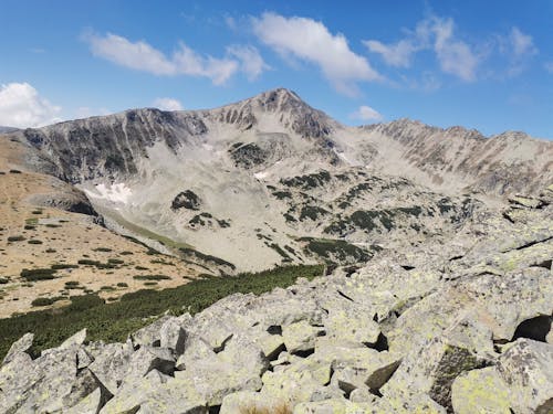 Blue Sky and Clouds above a Rocky Mountain