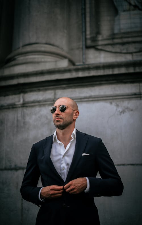 A Man in Black Suit Jacket Wearing Black Sunglasses