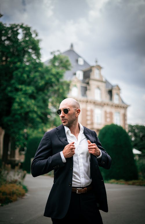 A Man in Black Suit Jacket and Black Pants