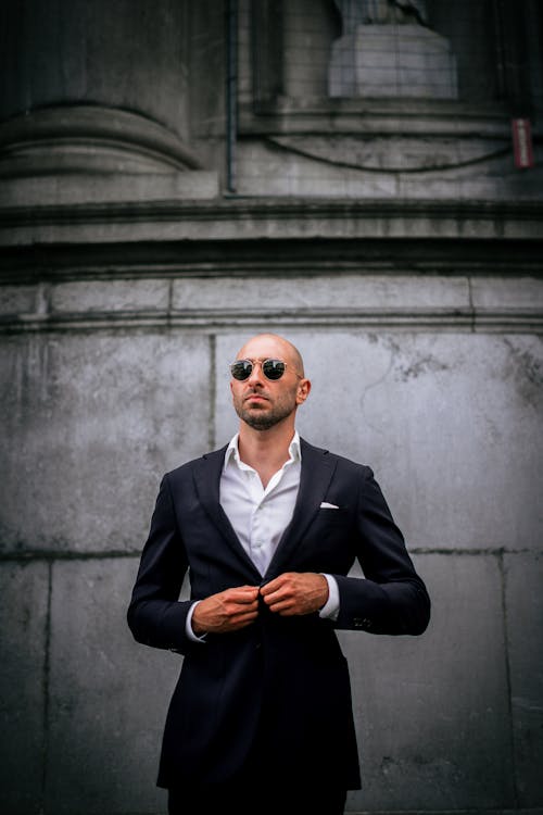 A Man in Black Suit Jacket Wearing Black Sunglasses