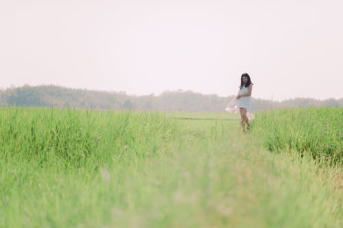 Woman Standing on Grass Field