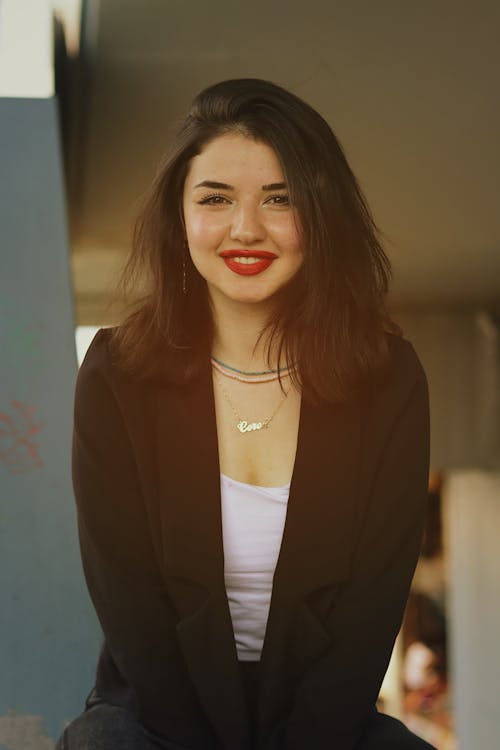 A Woman in Black Blazer Smiling at the Camera