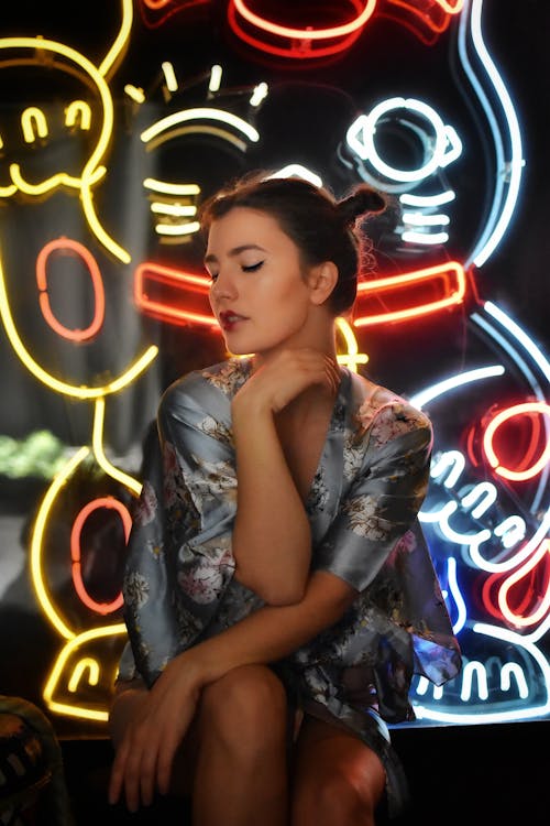 Woman Posing in a Kimono with Neons in the Background