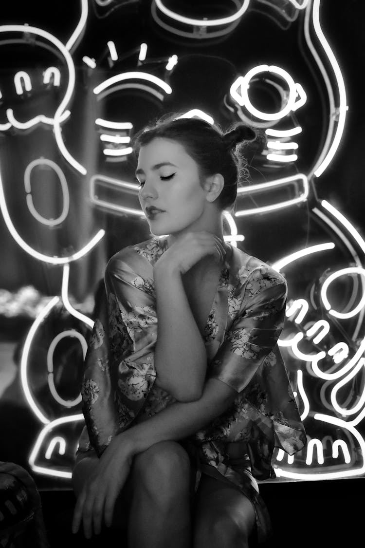 Woman Posing In A Kimono And Neons Behind Her In Grayscale