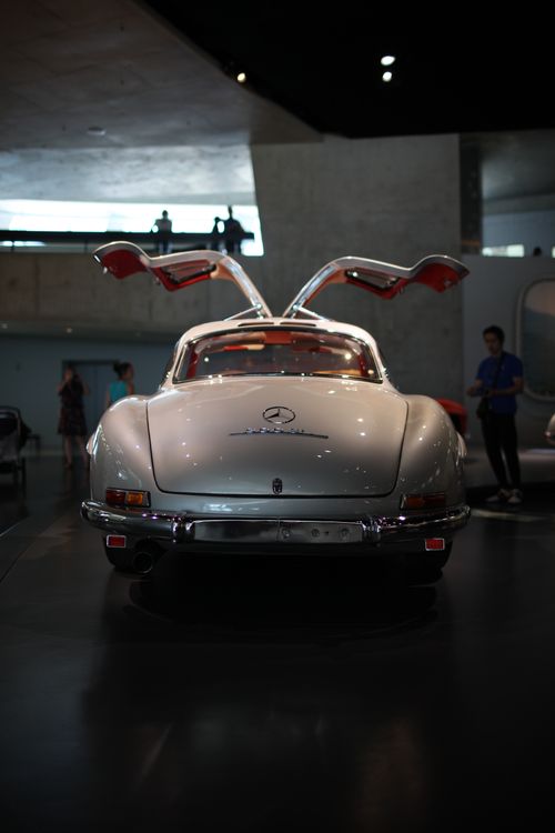 Free Vintage car with distinctive gullwing doors displayed in an indoor showroom setting. Stock Photo