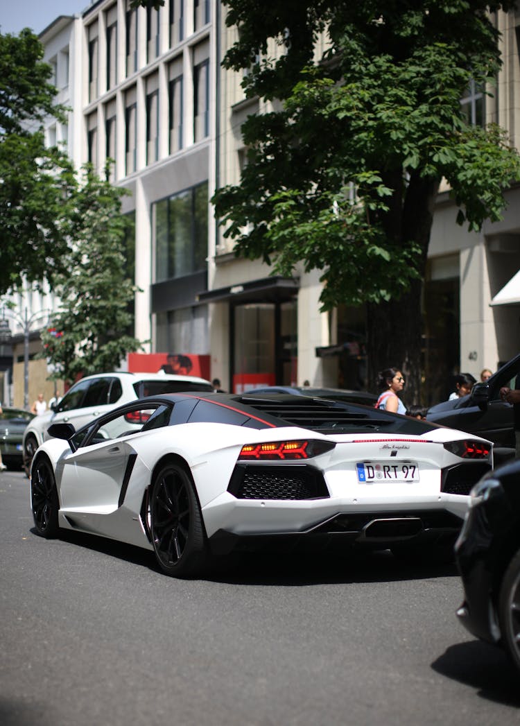 White And Black Lamborghini Parked On Street