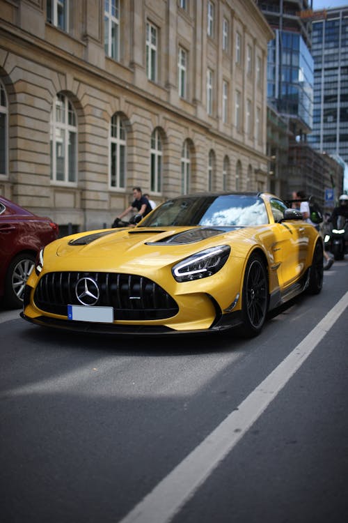 Yellow and Black Mercedes Benz on Road