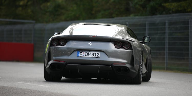 A Gray Luxury Car On The Road