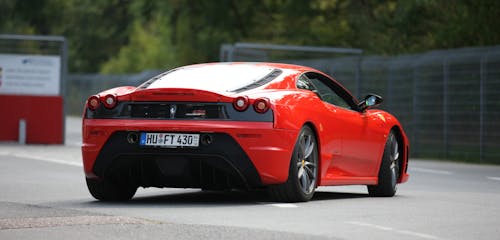 Red and Black Ferrari on Road