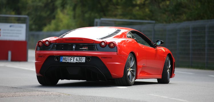 Red And Black Ferrari On Road