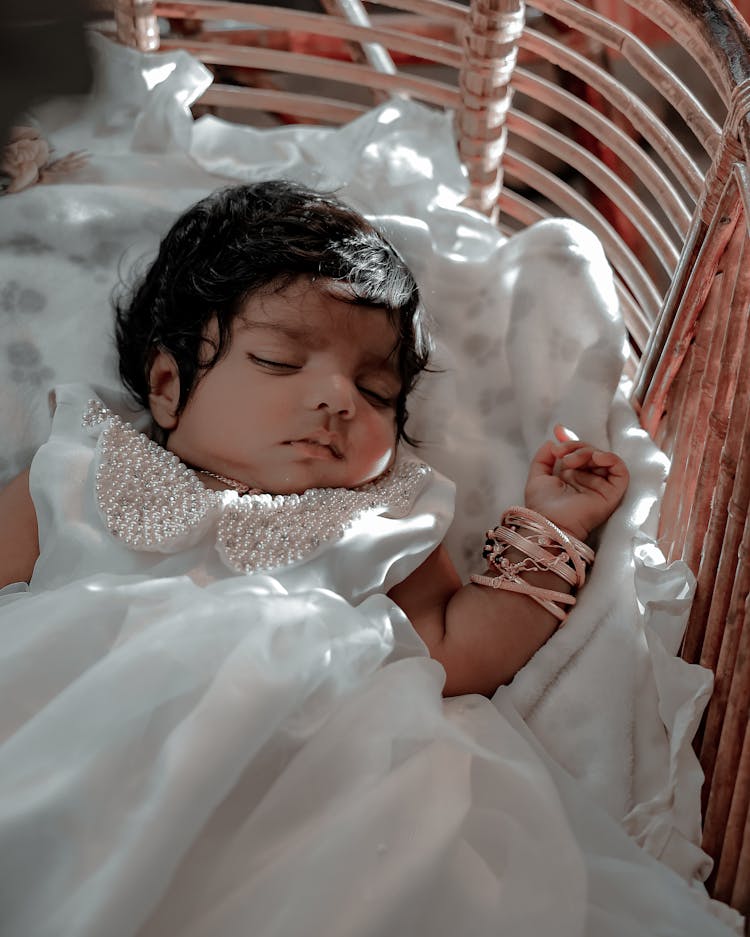 A Baby Girl In White Dress Sleeping