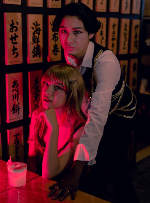 Couple Close Together at the Table in a Dark Room