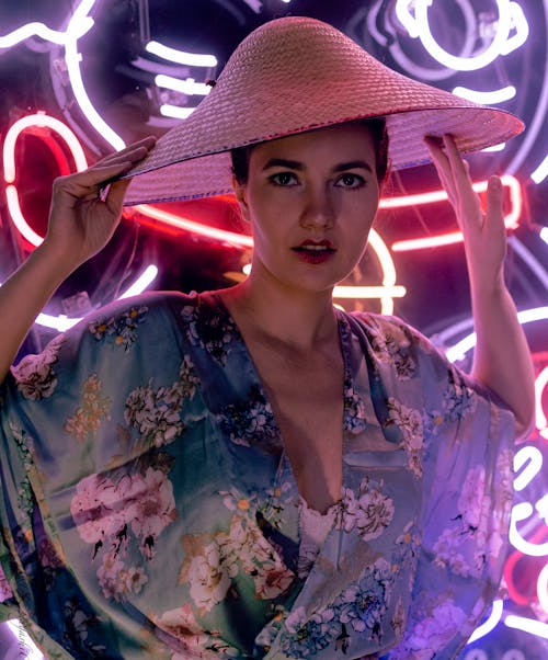 Woman in Floral Top Wearing Brown Straw Hat