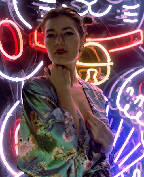 Attractive Woman Posing on Neon Lights in Background