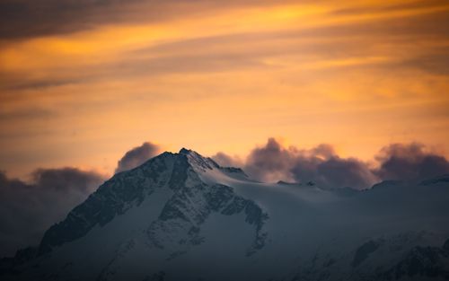 Free A stunning view of a snow-capped mountain during sunset in Madonna di Campiglio, Italy. Stock Photo