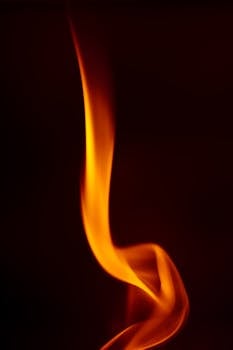 Close-up of a swirling flame on a dark background, evoking energy and warmth.