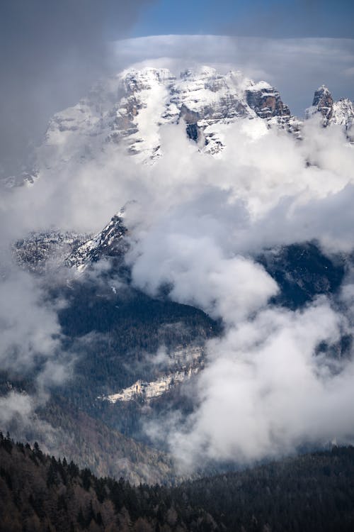 White Clouds over Snow Covered Mountain