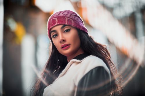 Free Portrait of a fashionable woman in an autumn setting, capturing cultural elegance in Tehran. Stock Photo
