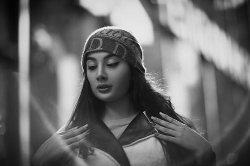 Black and White Photo of a Woman Posing with Her Hands on Her Chest