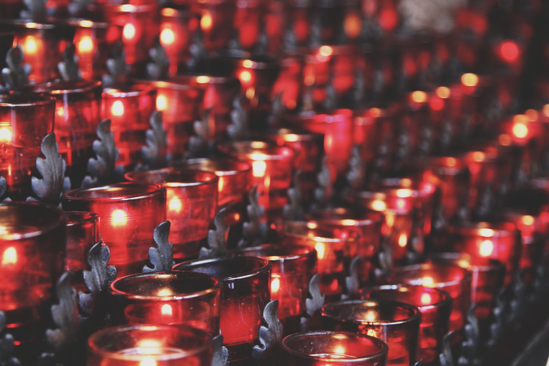 Close-up of vibrant red candle holders with flickering lights, creating a warm ambiance.
