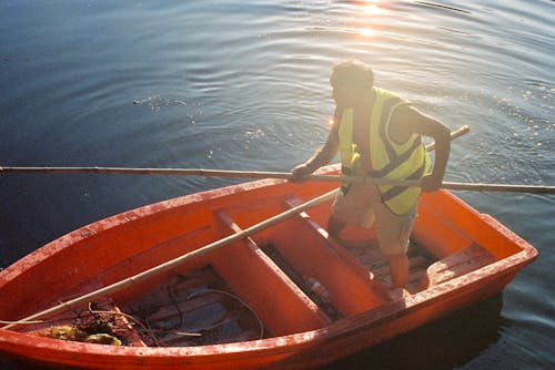 Fisherman in Reflective Vest on Boat