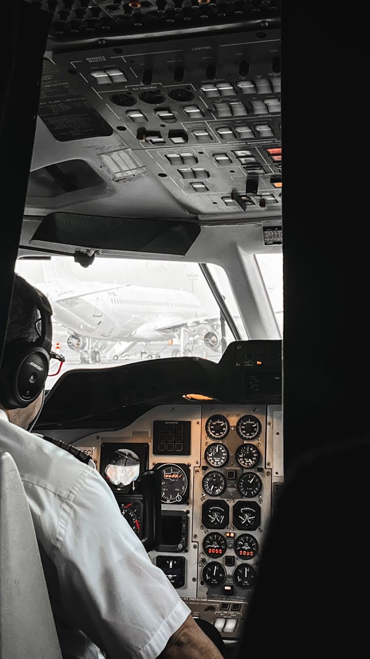 Pilot In Cockpit Seen Through Cracked Doors