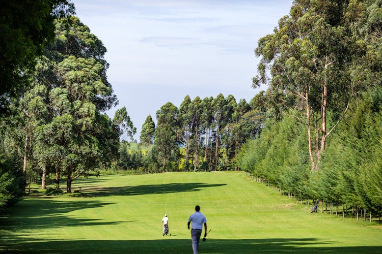 Men Playing Golf In Playground