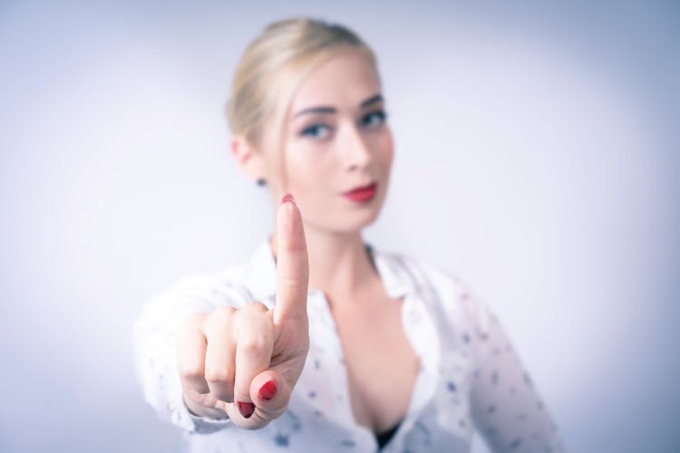 Blonde Woman Showing Her Index Finger 