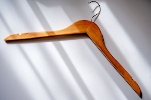 Brown Wooden Clothes Hanger on White Surface