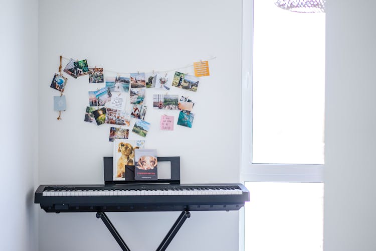 Synthesizer By Wall Decorated With Photos