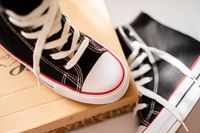 Black high-top sneakers with red trim resting on a shoebox — photo by Atlantic Ambience on Pexels