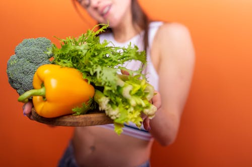 Woman Holding a Tray of Vegetables