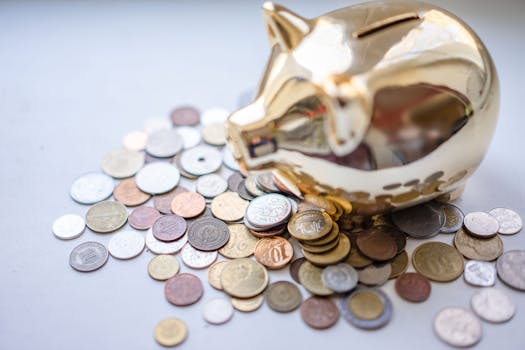 A golden piggy bank surrounded by assorted coins, symbolizing savings and wealth.