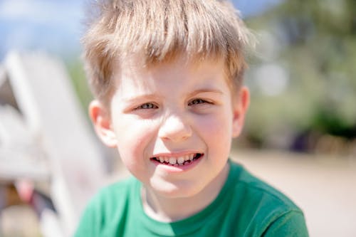 Boy in Green Crew Neck Shirt Smiling