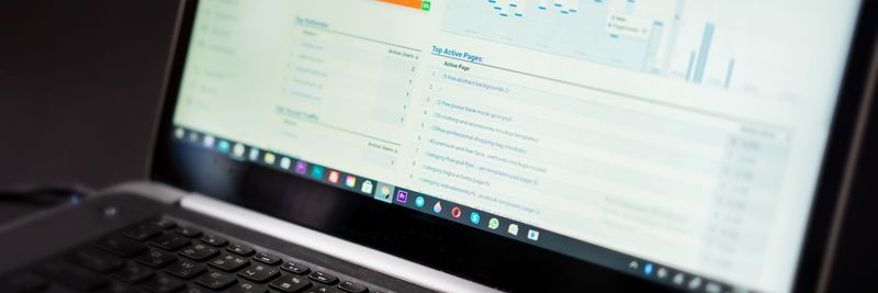 A laptop displaying an analytics dashboard with real-time data tracking and analysis tools.