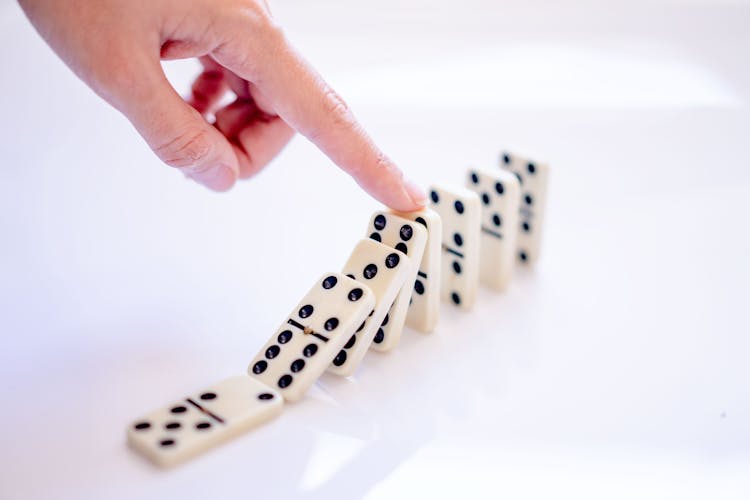Hand Holding Domino Blocks