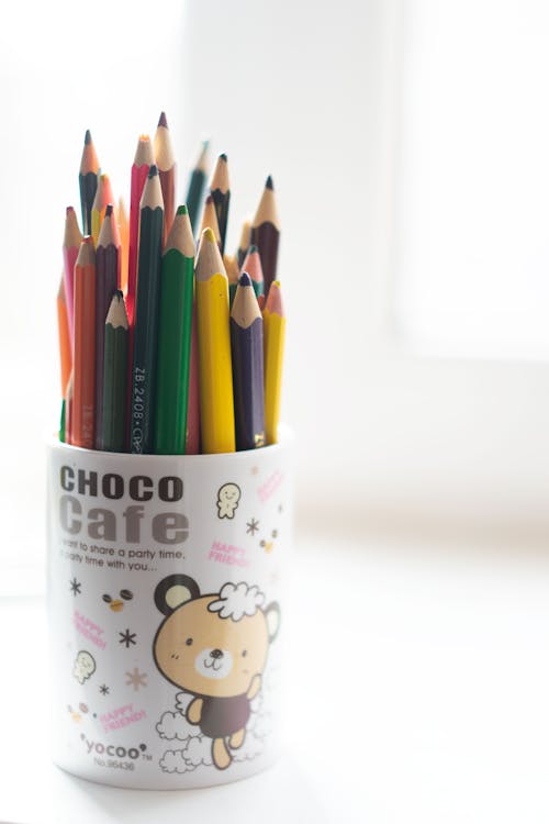 Color Pencils in the Cup on White Surface