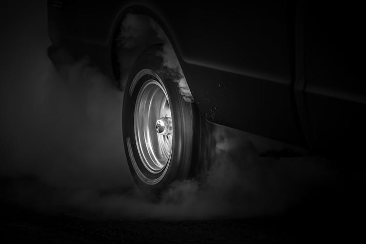 Grayscale Photo Of Spinning Tire