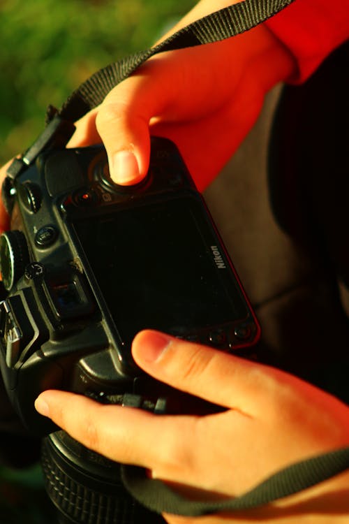 Person Holding Black Dslr Camera