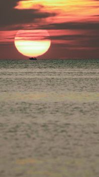 Stunning view of a sunset over the ocean with vibrant sky and calm waters.