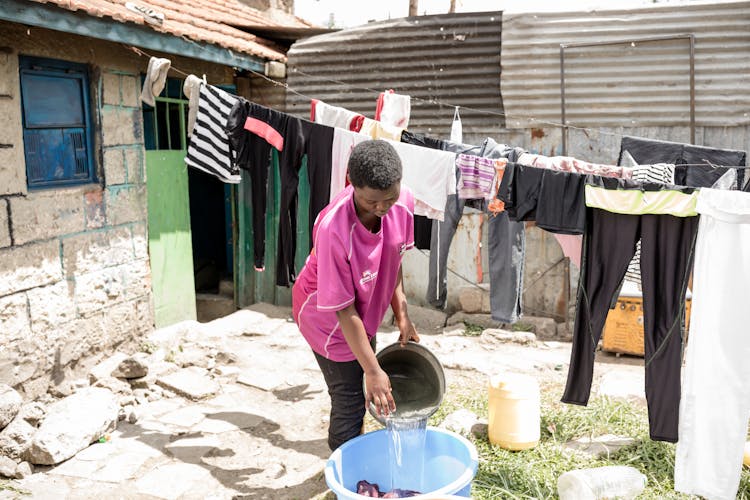 Girl Doing Laundry In The Yard