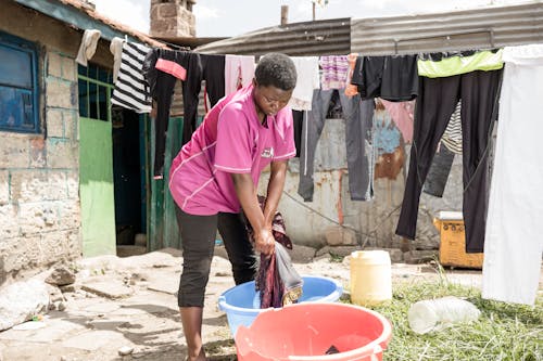 Free Girl Washing Clothes in the Yard Stock Photo