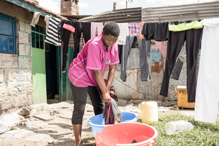 Girl Washing Clothes In The Yard