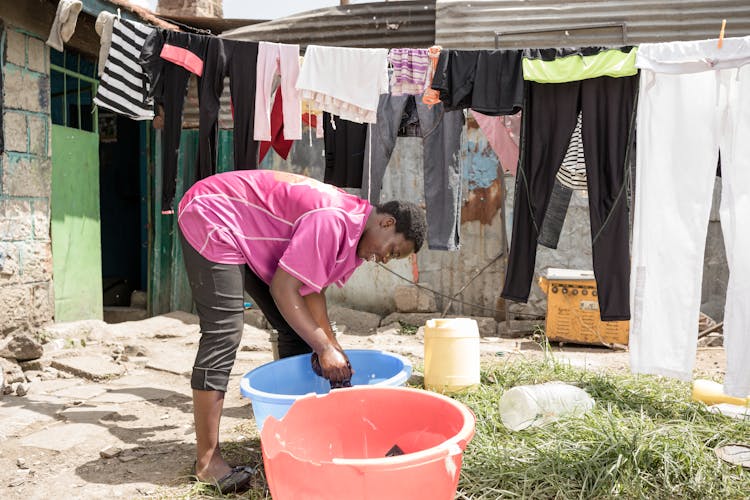 Girl Bending Over Basins While Doing Laundry